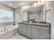 Well-lit bathroom features double sink vanity, soaking tub, and large mirror at 1211 Croft Dr, Fort Mill, SC 29708