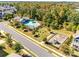 Aerial view of community pool, playground, and surrounding greenery on a sunny day at 1211 Croft Dr, Fort Mill, SC 29708