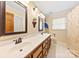 Bathroom with double sinks, neutral tile floor and a shower/tub at 1228 Graystone Dr, Gastonia, NC 28054