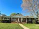 Charming brick home featuring a well-manicured lawn and inviting front porch at 1228 Graystone Dr, Gastonia, NC 28054