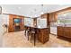 Open kitchen with a central island, bar seating, wine cooler, and updated appliances at 1228 Graystone Dr, Gastonia, NC 28054