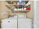 Functional laundry room with washer, dryer, and ample shelving storage at 1228 Graystone Dr, Gastonia, NC 28054