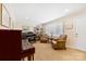 Bright living room with pianos, leather chairs, neutral carpet, and a well-lit interior at 1228 Graystone Dr, Gastonia, NC 28054