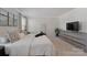 This bedroom features neutral walls, a large bed with white bedding, and a gray dresser topped with a TV at 126 Johns Cardinal Dr, Mooresville, NC 28115