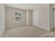 Bright, carpeted bedroom with a window and neutral walls, ready for personal touches at 126 Johns Cardinal Dr, Mooresville, NC 28115