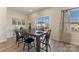Bright dining room with wood floors, long wooden table and chairs, and backyard views at 126 Johns Cardinal Dr, Mooresville, NC 28115