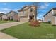 Charming two-story home with a well-manicured lawn and neutral colored exterior at 126 Johns Cardinal Dr, Mooresville, NC 28115