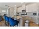 Modern kitchen featuring an island with barstool seating, granite countertops, and stainless appliances at 126 Johns Cardinal Dr, Mooresville, NC 28115