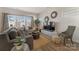 Bright living room featuring hardwood floors, modern furnishings, and plentiful natural light at 126 Johns Cardinal Dr, Mooresville, NC 28115