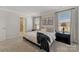 Bright main bedroom with windows, soft carpet, and ensuite bathroom entrance at 126 Johns Cardinal Dr, Mooresville, NC 28115