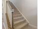 Carpeted staircase with white risers and stained wood handrail, blending comfort with architectural detail at 126 Johns Cardinal Dr, Mooresville, NC 28115