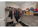 Bright walk-in closet featuring white shelves and a rod to hang clothes and store shoes at 126 Johns Cardinal Dr, Mooresville, NC 28115