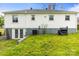 Rear view of the house with walk-out basement, and an exterior BBQ grill in the backyard at 1301 Jackson St, Kannapolis, NC 28083
