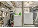 Unfinished basement area includes washer, dryer, storage shelves, and mechanical components at 1301 Jackson St, Kannapolis, NC 28083