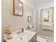 Charming bathroom with tile walls, modern vanity, and natural light from the window at 1301 Jackson St, Kannapolis, NC 28083