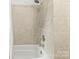 Clean and modern bathroom featuring tiled walls and a bathtub with shower at 1301 Jackson St, Kannapolis, NC 28083