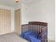Bright Bedroom with a dark wooden crib with blue bedding and neutral-toned walls at 1301 Jackson St, Kannapolis, NC 28083