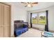 Well-lit Bedroom features neutral carpet and trim plus a wooden crib with a window view at 1301 Jackson St, Kannapolis, NC 28083