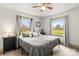 Bright bedroom with two large windows, neutral bedding, and black bedside table at 1301 Jackson St, Kannapolis, NC 28083