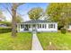 Charming single-story home with a welcoming front porch and well-maintained lawn on a sunny day at 1301 Jackson St, Kannapolis, NC 28083
