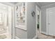 Hallway with built-in shelves showcasing decorative items, with a view of the bathroom and bedroom at 1301 Jackson St, Kannapolis, NC 28083
