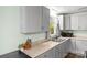 This renovated kitchen features modern cabinets, neutral countertops, and stainless steel sink at 1301 Jackson St, Kannapolis, NC 28083