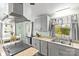 Updated kitchen features modern stainless steel appliances, gray cabinets and a functional layout at 1301 Jackson St, Kannapolis, NC 28083