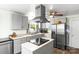 Well-lit kitchen boasts stainless steel appliances, a center island, and ample cabinet space at 1301 Jackson St, Kannapolis, NC 28083