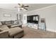 Cozy living room featuring a large sectional sofa, neutral carpet, and modern ceiling fan at 1301 Jackson St, Kannapolis, NC 28083