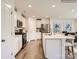 Modern eat-in kitchen with stainless steel appliances, a large island, and pristine white cabinetry at 156 Mountain Bridge Way, Statesville, NC 28625