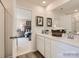 Bright and airy main bathroom with a double sink vanity and a glimpse into the adjoining bedroom at 156 Mountain Bridge Way, Statesville, NC 28625