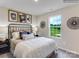 Comfortable bedroom with a decorative headboard, natural light, and modern accents at 160 Mountain Bridge Way, Statesville, NC 28625