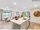 Open kitchen area with an island bar facing the dining and living areas with natural lighting at 160 Mountain Bridge Way, Statesville, NC 28625