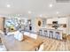 Open-concept kitchen and dining area featuring modern white cabinets and stylish breakfast bar with seating at 160 Mountain Bridge Way, Statesville, NC 28625