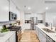 Modern kitchen featuring stainless steel appliances, light countertops, and ample cabinet space at 160 Mountain Bridge Way, Statesville, NC 28625