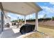 Covered back patio provides a shaded seating area overlooking the yard at 1774 Slippery Rock Ln, Monroe, NC 28112