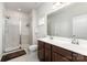 Bathroom with double sink vanity, shower with glass door, and decorative mirror at 1774 Slippery Rock Ln, Monroe, NC 28112