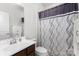 Clean bathroom with decorative shower curtain, white cabinets, and single sink vanity at 1774 Slippery Rock Ln, Monroe, NC 28112