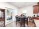 Bright breakfast nook features wood floors, patio access, and kitchen bar with liquor cabinet at 1774 Slippery Rock Ln, Monroe, NC 28112