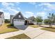 Beautiful, one-story home featuring a well-kept lawn and driveway, complemented by the blue sky at 1774 Slippery Rock Ln, Monroe, NC 28112