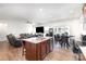 Open kitchen and living area featuring a large island, stainless steel appliances, and ample seating at 1774 Slippery Rock Ln, Monroe, NC 28112