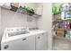 Functional laundry room with washer, dryer, and shelving for organized storage at 1774 Slippery Rock Ln, Monroe, NC 28112
