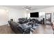 Spacious living room with plush black leather seating and neutral walls, perfect for relaxation at 1774 Slippery Rock Ln, Monroe, NC 28112