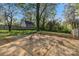 Spacious backyard featuring a concrete slab surrounded by a privacy fence and mature trees at 1814 Eastway Dr, Charlotte, NC 28205