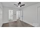 Bright bedroom with hardwood floors, ceiling fan and a view to an ensuite bath at 1814 Eastway Dr, Charlotte, NC 28205