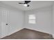Clean bedroom with hardwood floors, ceiling fan, neutral paint and a window for natural light at 1814 Eastway Dr, Charlotte, NC 28205