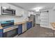 Updated kitchen boasts stainless appliances, custom cabinets, and a stylish sliding barn door at 1814 Eastway Dr, Charlotte, NC 28205
