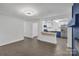Open living space with sleek flooring and a view of the beautifully appointed kitchen at 1814 Eastway Dr, Charlotte, NC 28205