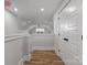 Hallway on second floor landing with wood floor, white walls, white doors, and window at 2074 Fordhill St, Rock Hill, SC 29732