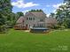 Expansive backyard features a lovely deck with an inviting above ground pool, perfect for outdoor entertaining and relaxation at 217 Blossom Hill Rd, Lincolnton, NC 28092